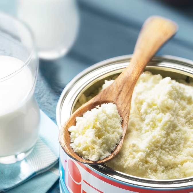 Milk powder can with a wooden spoon