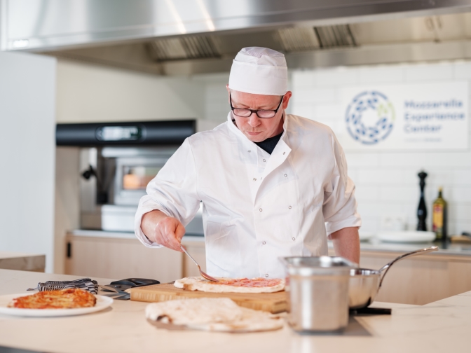 Mozzarella experience center chef making pizza