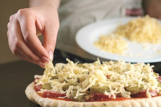 Shredded mozzarella on pizza