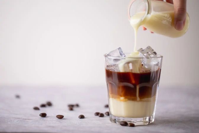 Skimmed milk poured in coffee
