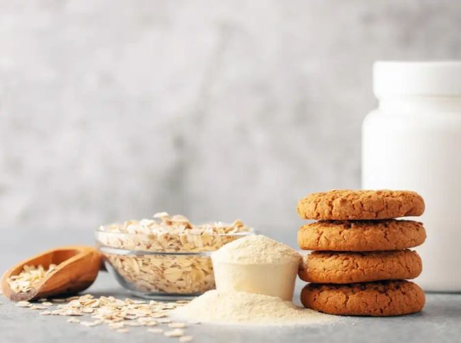 Whey Permeate powder next to oats and cookies
