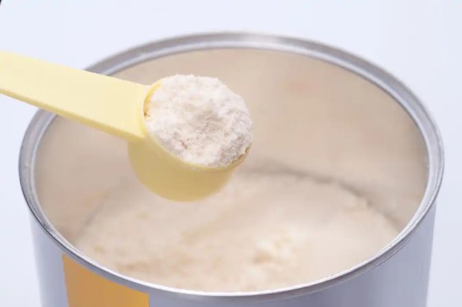 Milk powder can with a plastic spoon