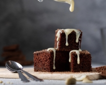 Brownies getting dripped by cream